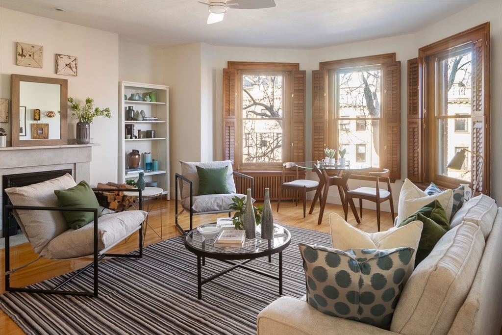 a living room with furniture and large windows