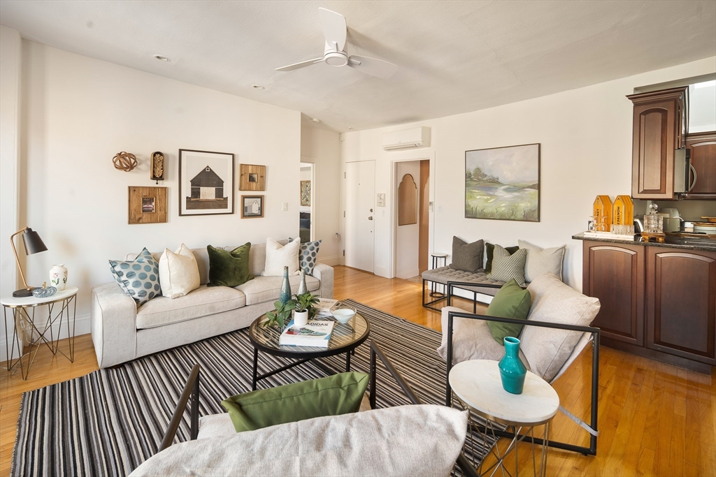 413 Beacon Street, Unit 5 Boston, MA 02115 - Photo 5 of 19 a living room with furniture and wooden floor