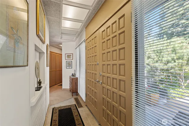 a living room with furniture and next to a large window