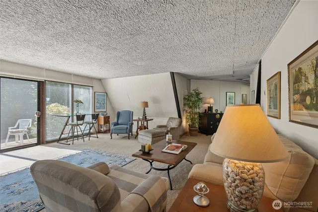 a living room with furniture and large windows