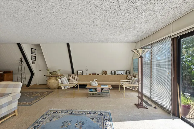 a balcony view with two chairs and a table