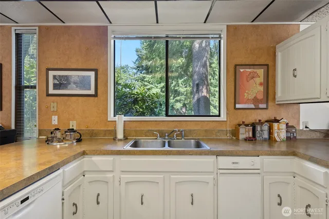 a large kitchen with a sink and cabinets