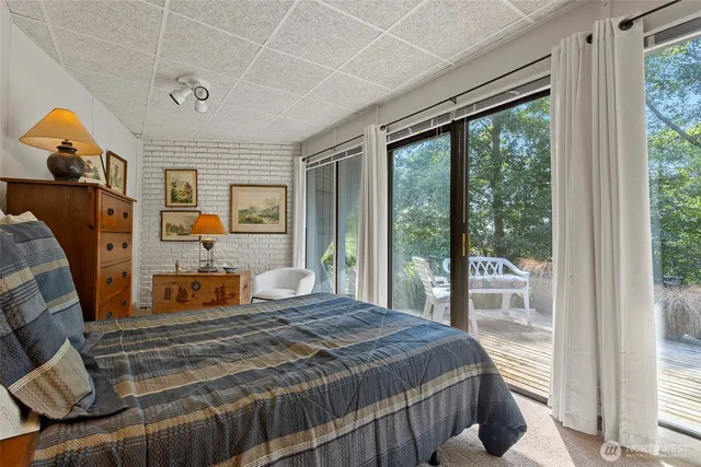 a bedroom with furniture and large windows