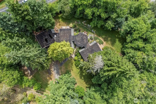 an aerial view of a house with a yard