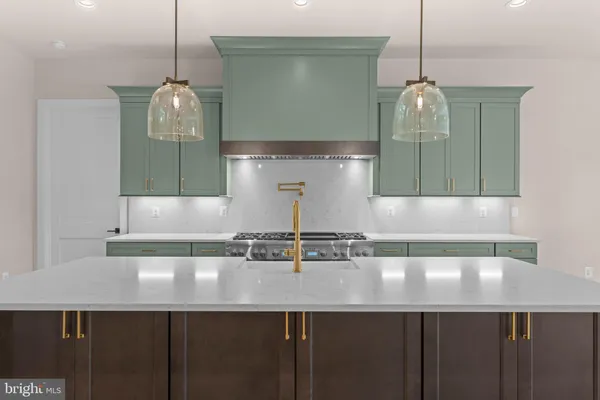 a kitchen with a stove sink and refrigerator