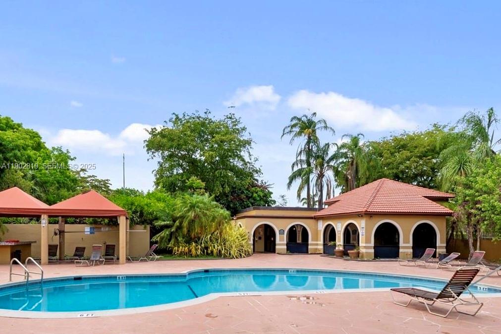 15550 Southwest 80th Street, Unit E101 Miami, FL 33193 - Photo 15 of 21 a house view with a garden space