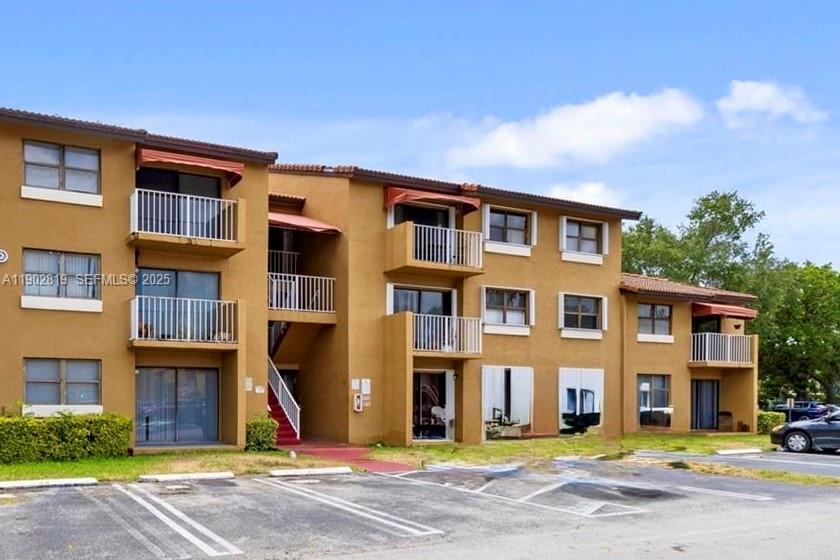 15550 Southwest 80th Street, Unit E101 Miami, FL 33193 - Photo 16 of 21 a front view of a building with street view