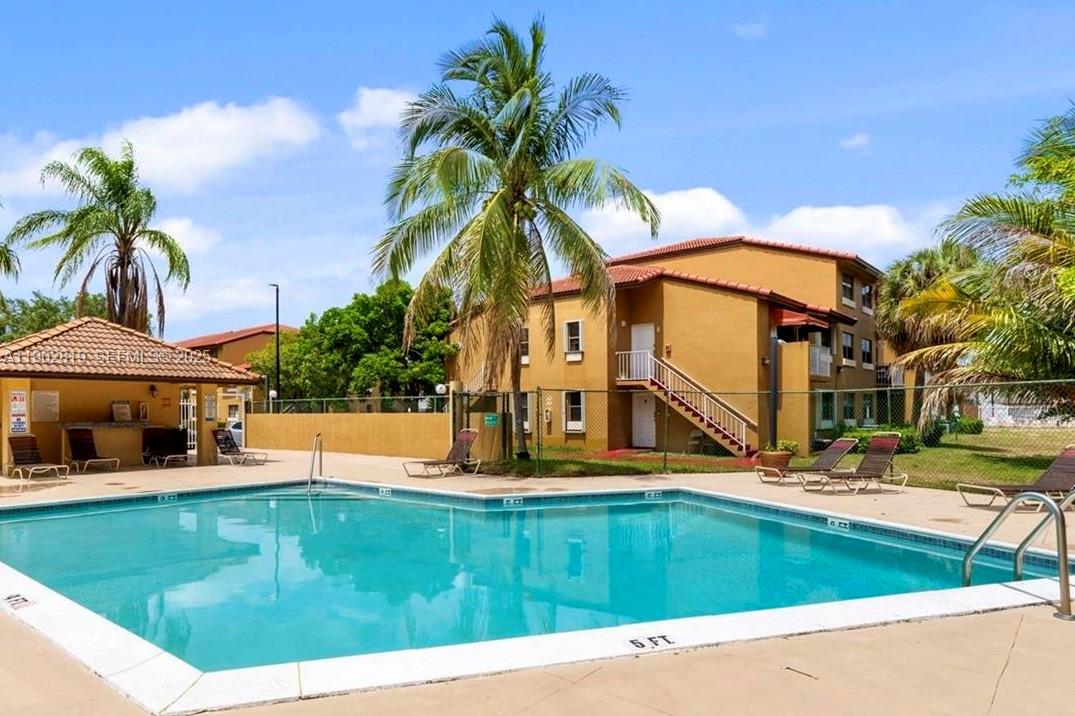 15550 Southwest 80th Street, Unit E101 Miami, FL 33193 - Photo 18 of 21 a view of a house with pool and sitting area