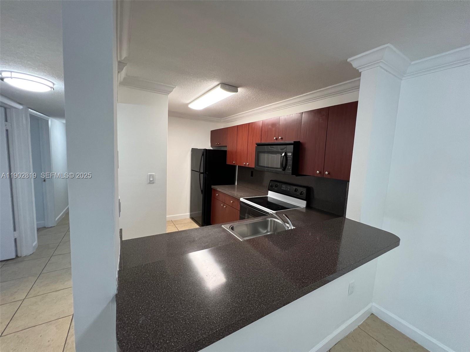 15550 Southwest 80th Street, Unit E101 Miami, FL 33193 - Photo 4 of 21 a view of a kitchen with a sink