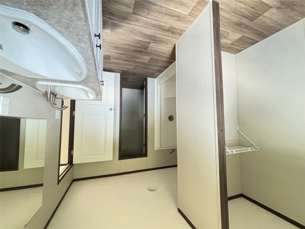 277 Elm Forest Loop, Unit B Cedar Creek, TX 78612 - Photo 11 of 26 a bathroom with a sink and a mirror