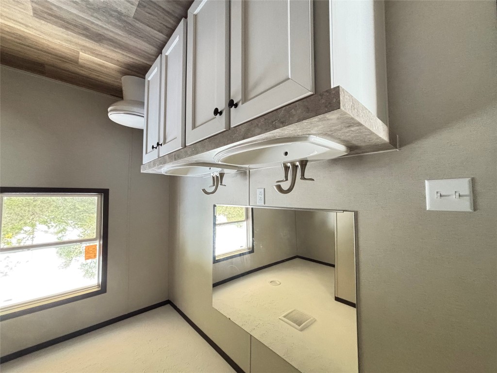 277 Elm Forest Loop, Unit B Cedar Creek, TX 78612 - Photo 12 of 26 a bathroom with a toilet sink and mirror