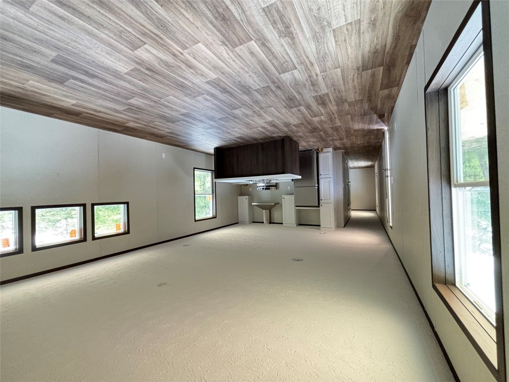 277 Elm Forest Loop, Unit B Cedar Creek, TX 78612 - Photo 25 of 26 a view of a big room with wooden floor and windows