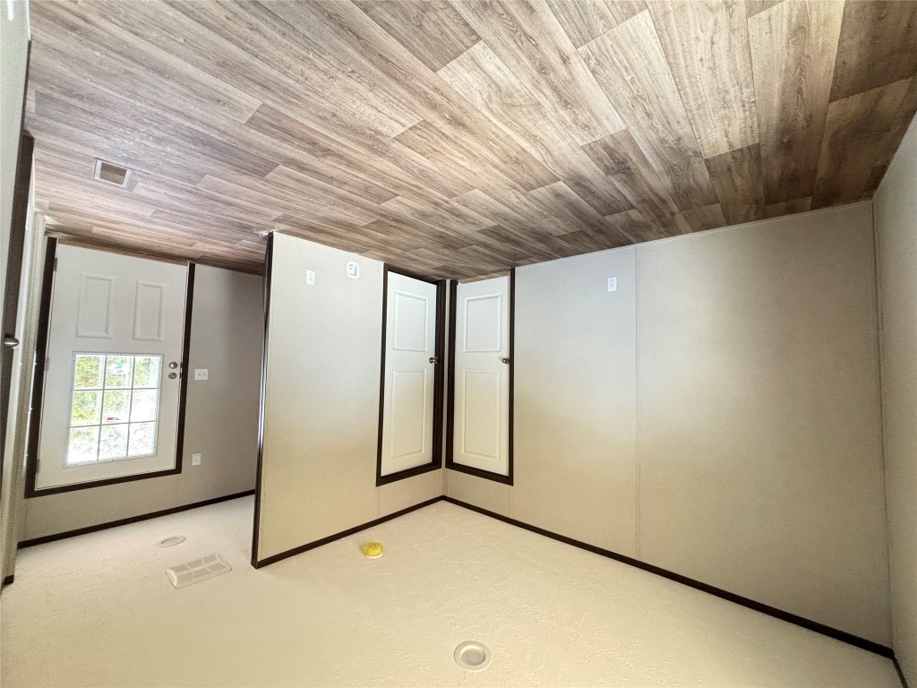 277 Elm Forest Loop, Unit B Cedar Creek, TX 78612 - Photo 15 of 26 a view of empty room with wooden floor and fan