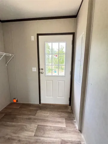 a view of a livingroom with wooden floor and window