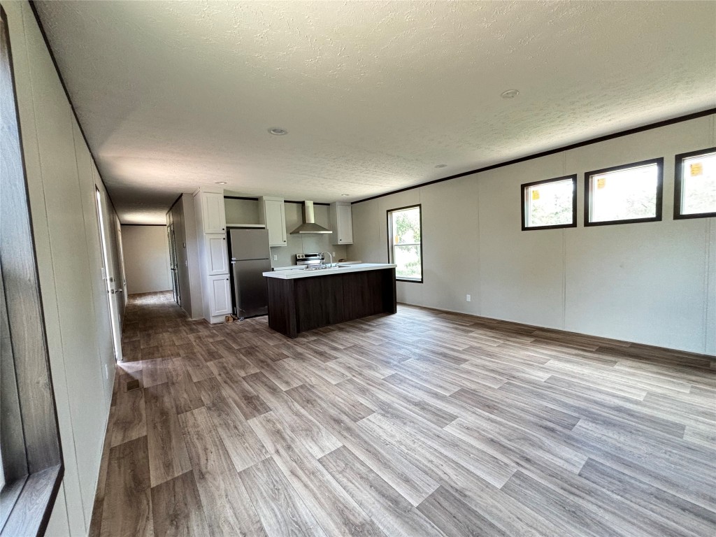 277 Elm Forest Loop, Unit B Cedar Creek, TX 78612 - Photo 26 of 26 a view of kitchen and wooden floor