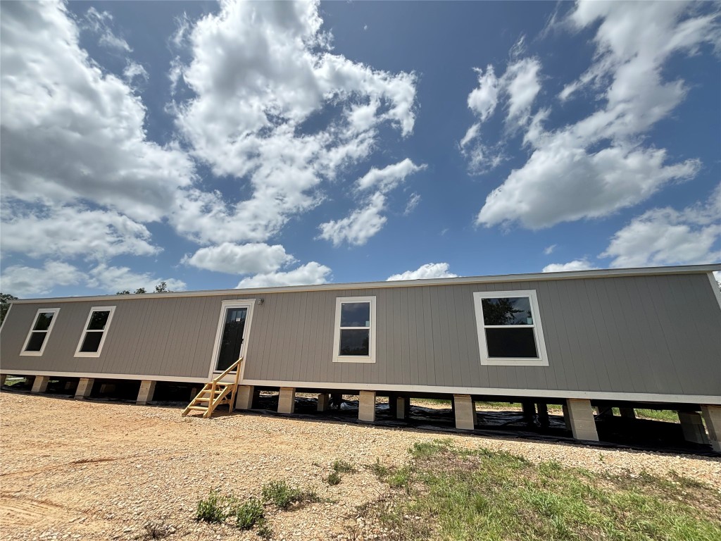 277 Elm Forest Loop, Unit B Cedar Creek, TX 78612 - Photo 22 of 26 a front view of house with yard