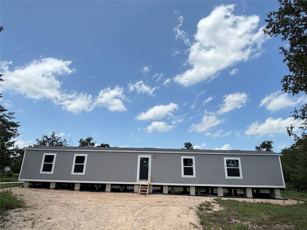 277 Elm Forest Loop, Unit B Cedar Creek, TX 78612 - Photo 3 of 26 a front view of a house with a yard