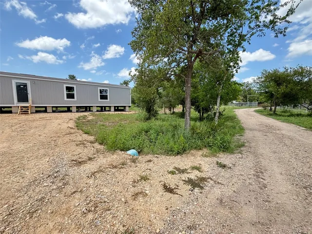 a view of a backyard of the house