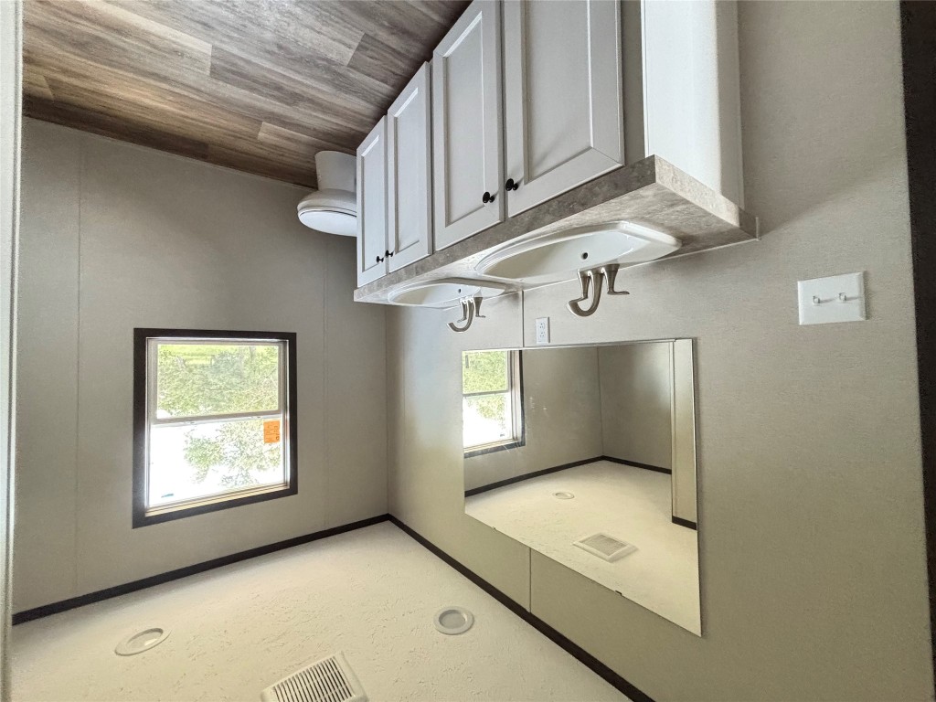 277 Elm Forest Loop, Unit B Cedar Creek, TX 78612 - Photo 10 of 26 a bathroom with a toilet sink and mirror