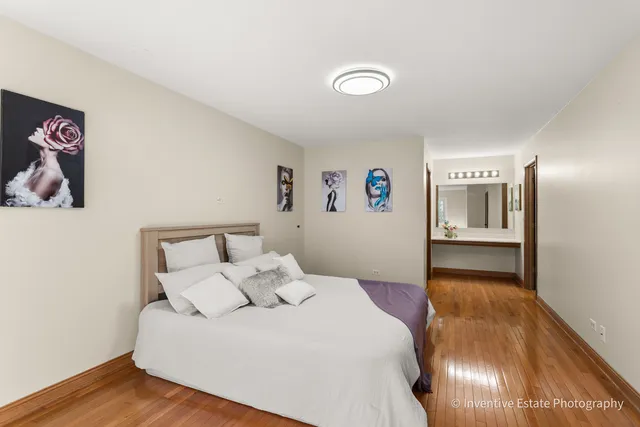 a bedroom with a large bed and a view of kitchen