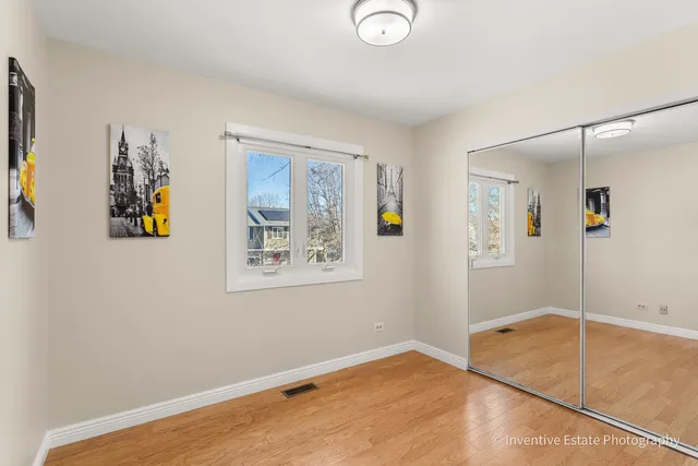 a view of a livingroom with wooden floor and a window