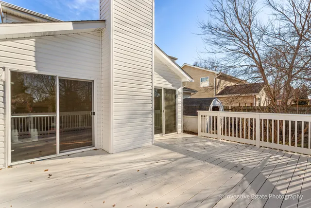 a view of a house with a wooden deck