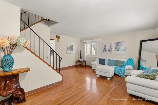 a living room with furniture and a wooden floor