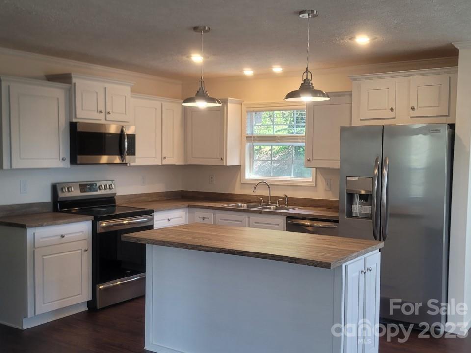 33 Hampton Heights Road Canton, NC 28716 - Photo 9 of 10 a kitchen with stainless steel appliances granite countertop a sink stove and refrigerator