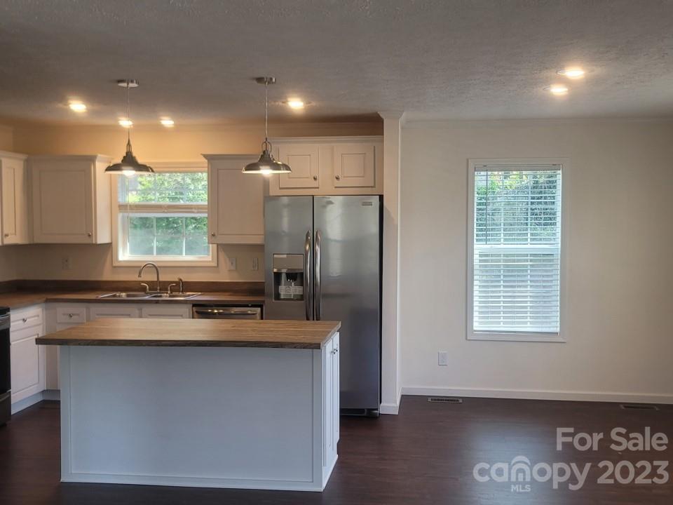33 Hampton Heights Road Canton, NC 28716 - Photo 10 of 10 a kitchen with kitchen island granite countertop a stove and a refrigerator