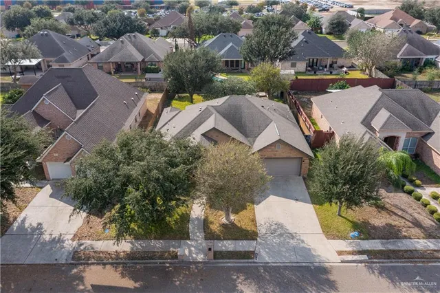 an aerial view of residential houses with outdoor space