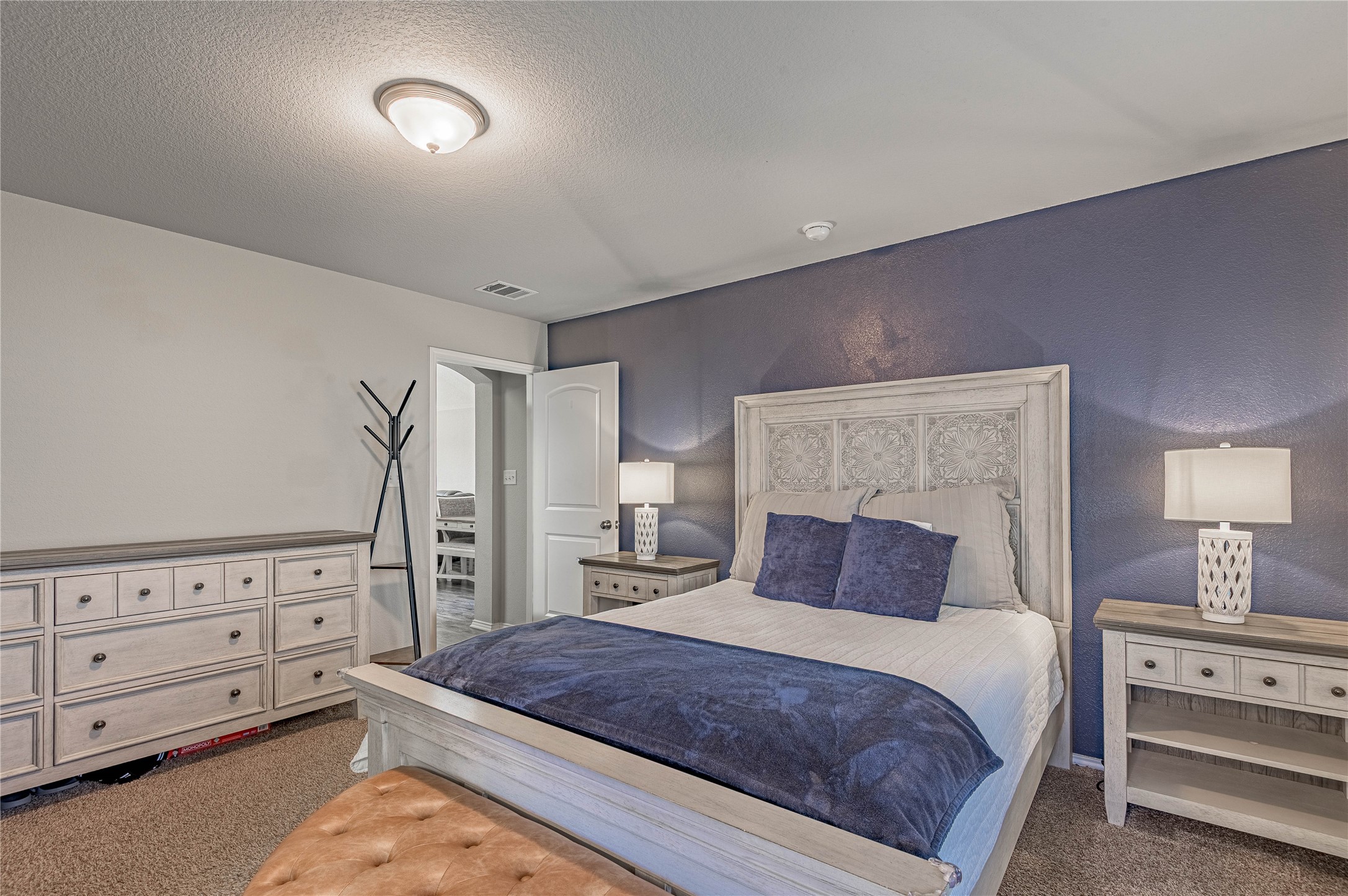 133 Bates Court Huntsville, TX 77320 - Photo 11 of 31 a bedroom with a bed and a dresser