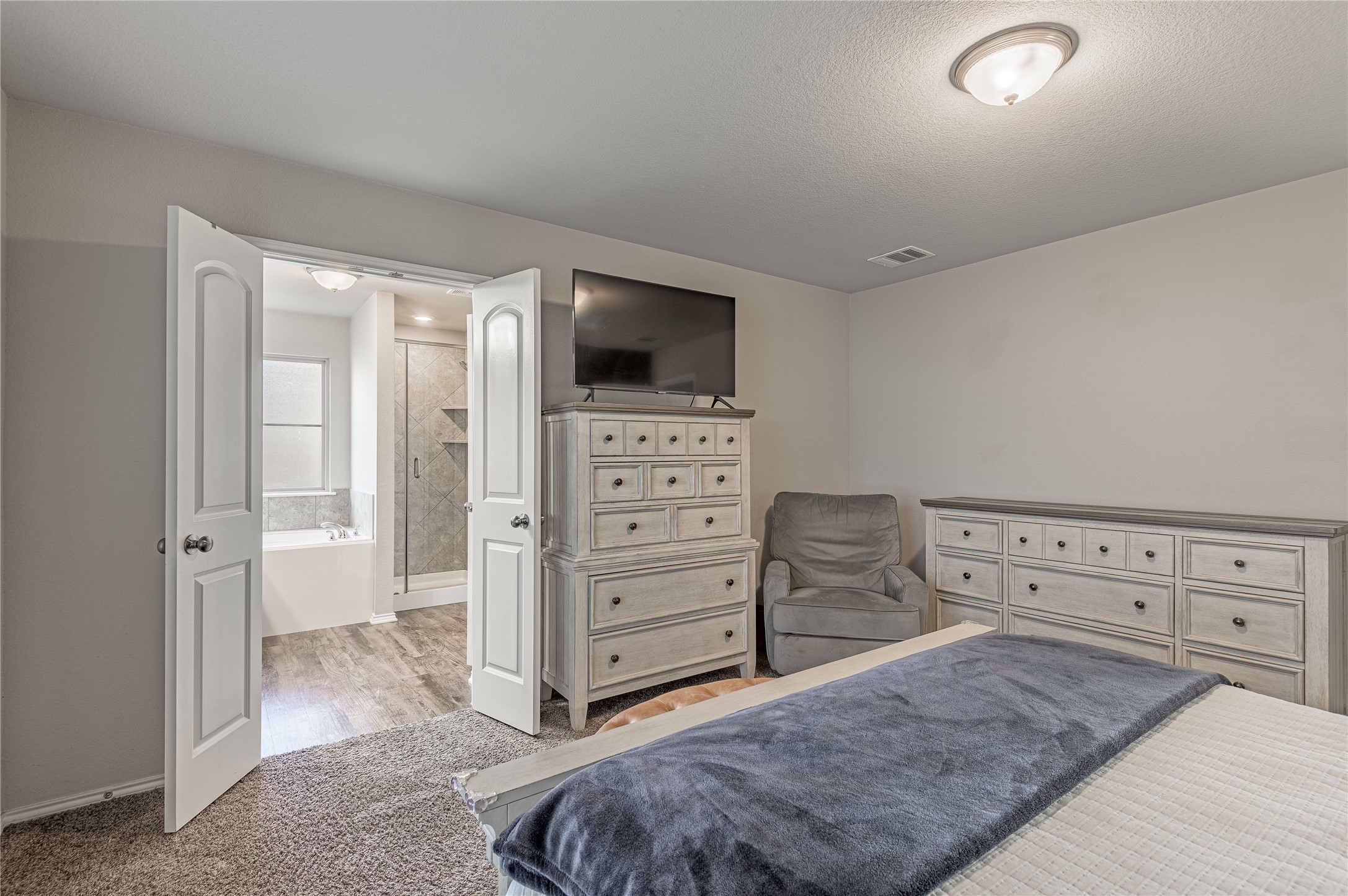 133 Bates Court Huntsville, TX 77320 - Photo 12 of 31 a view of a bedroom with furniture and flat screen tv