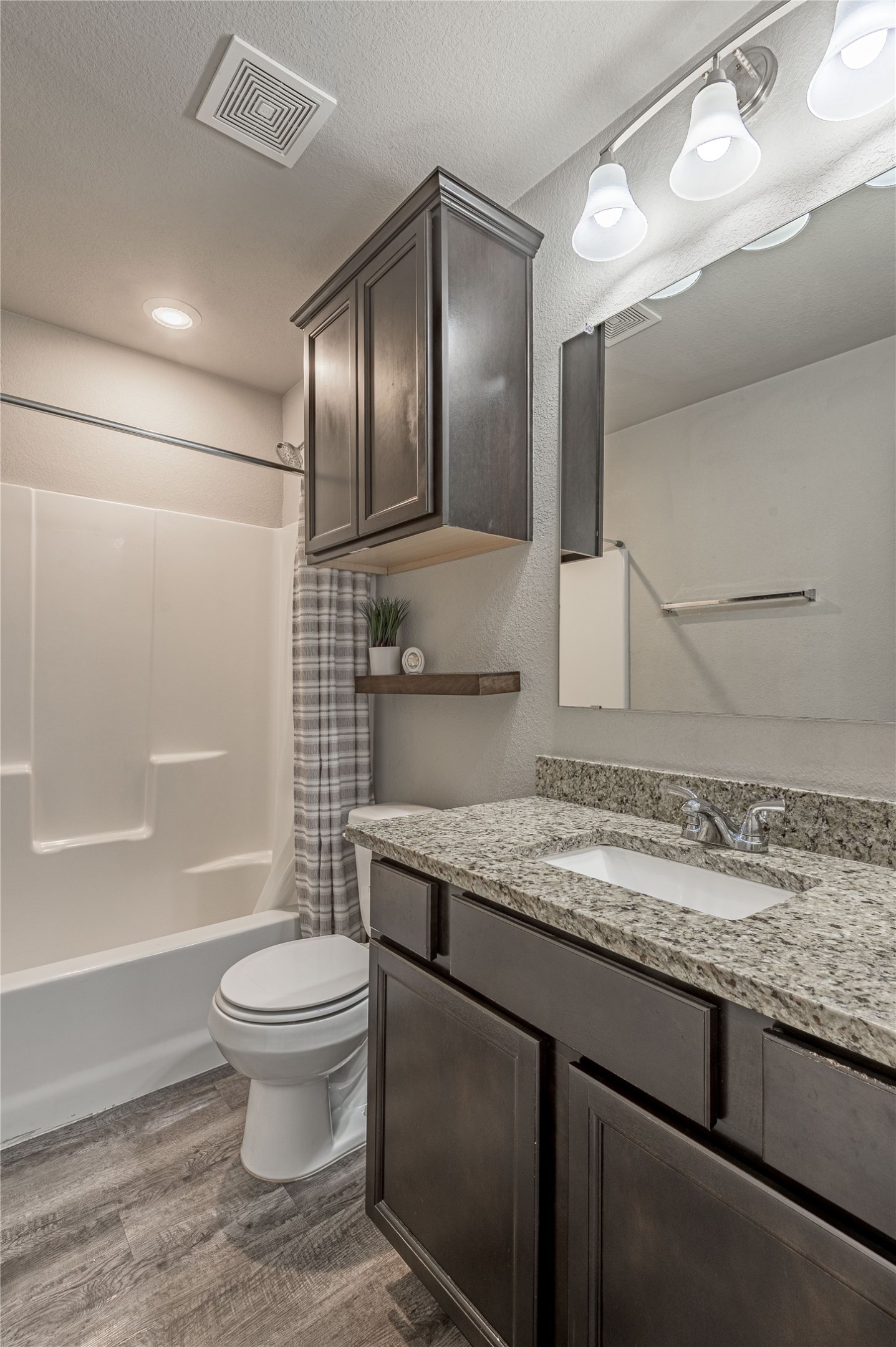 133 Bates Court Huntsville, TX 77320 - Photo 19 of 31 a bathroom with a granite countertop sink toilet and shower