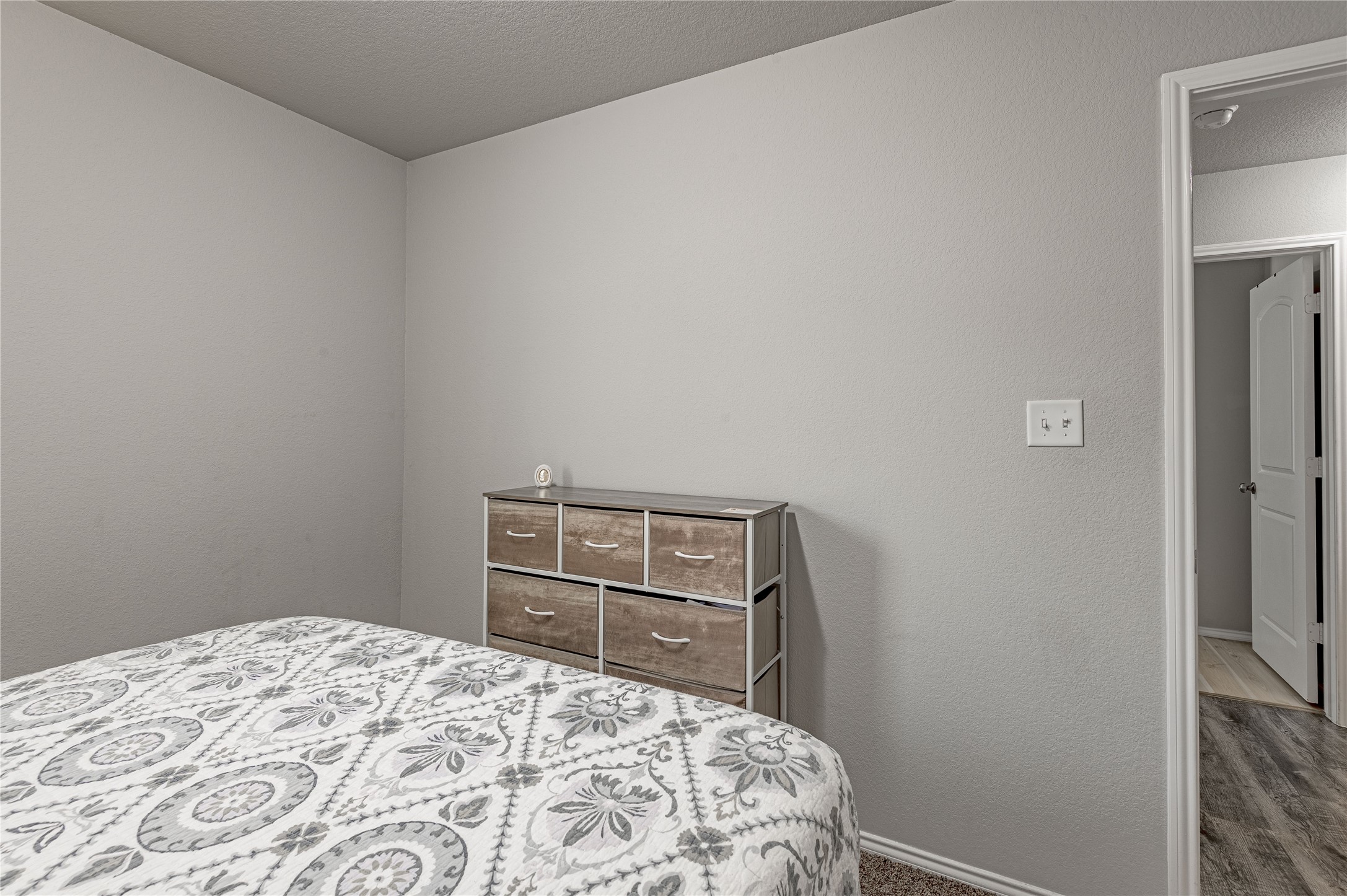 133 Bates Court Huntsville, TX 77320 - Photo 21 of 31 a bedroom with a bed and a cabinets