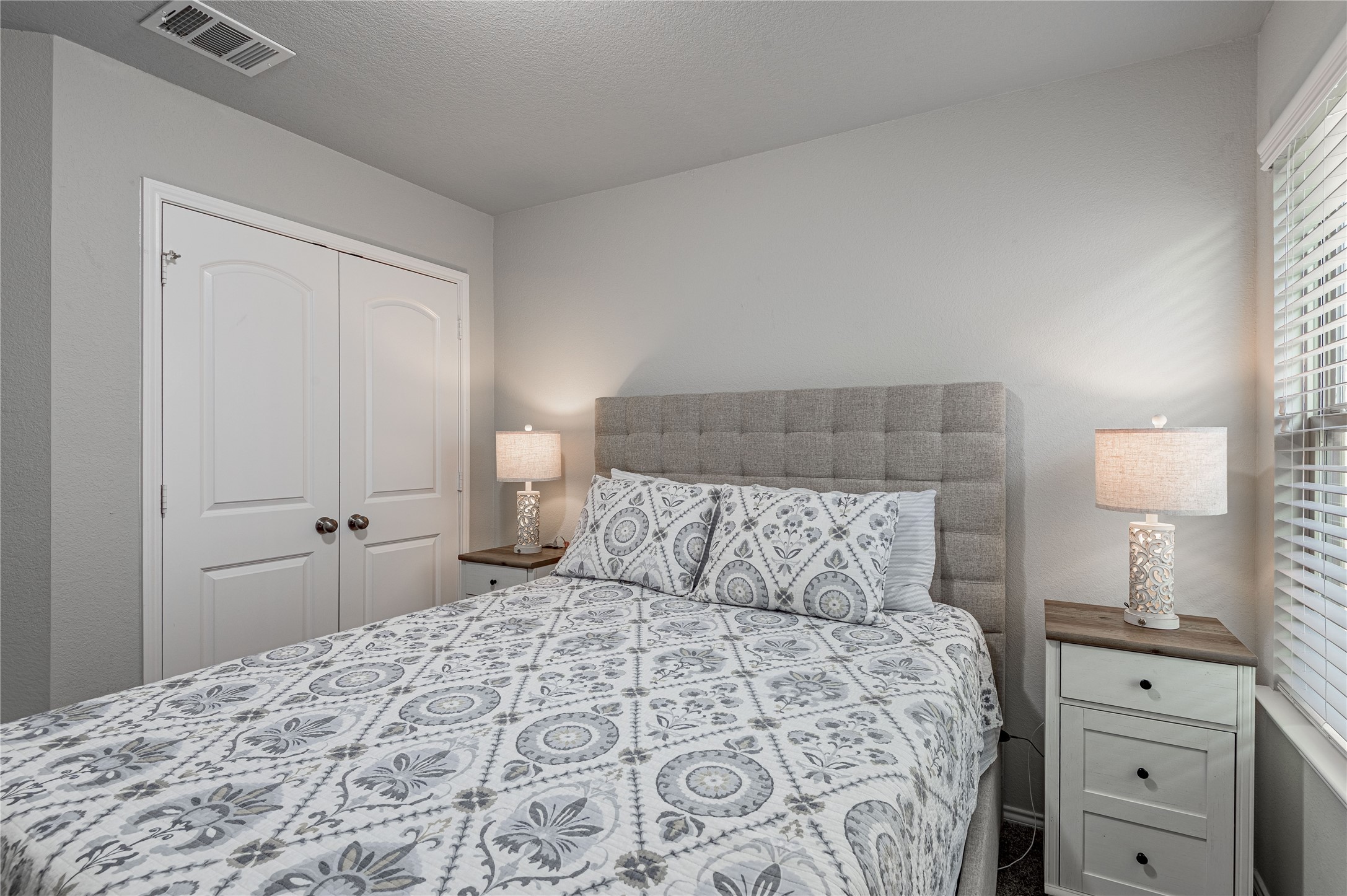 133 Bates Court Huntsville, TX 77320 - Photo 22 of 31 a bedroom with a bed and a lamp