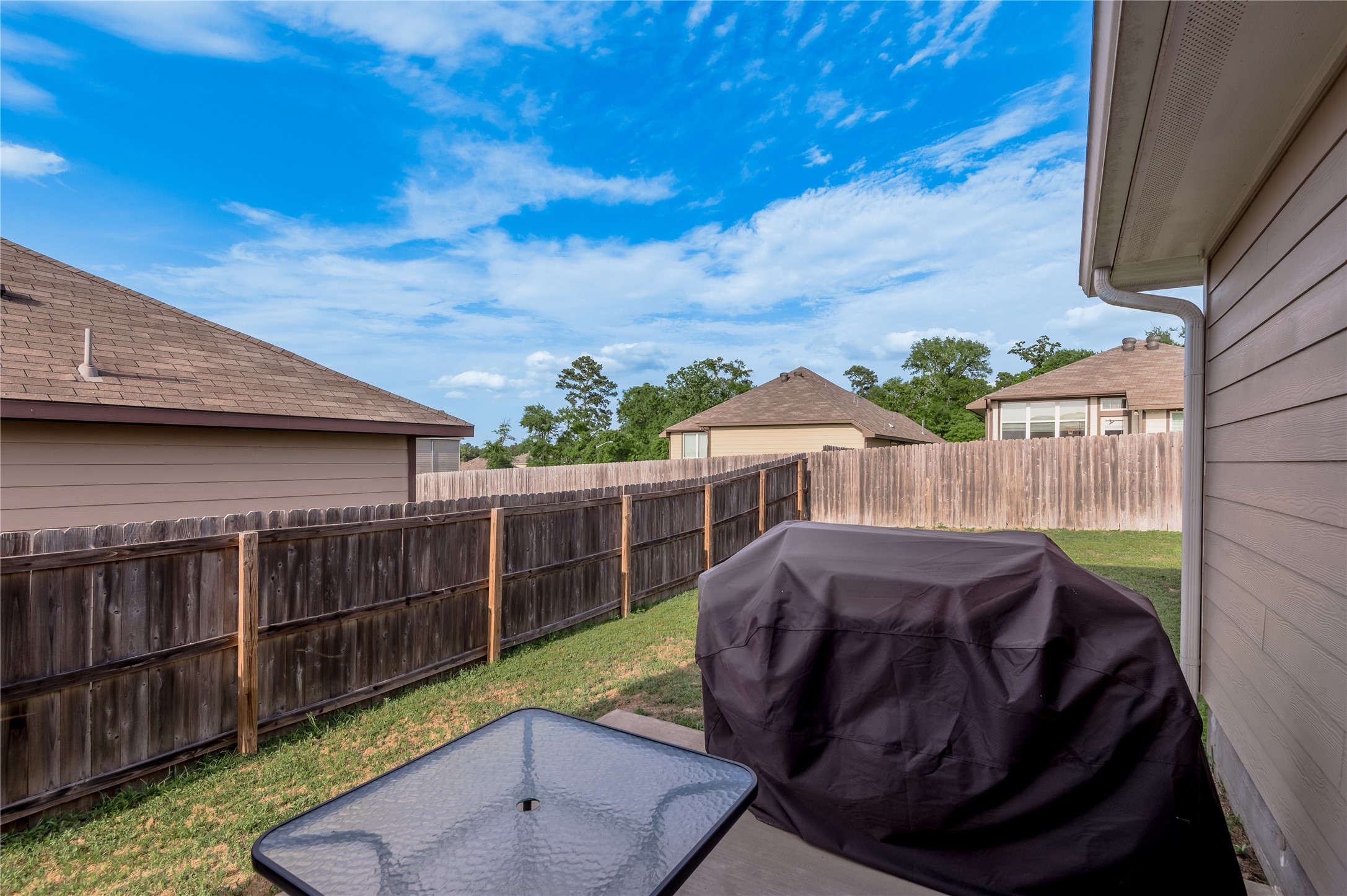 133 Bates Court Huntsville, TX 77320 - Photo 27 of 31 a view of backyard with deck and outdoor seating