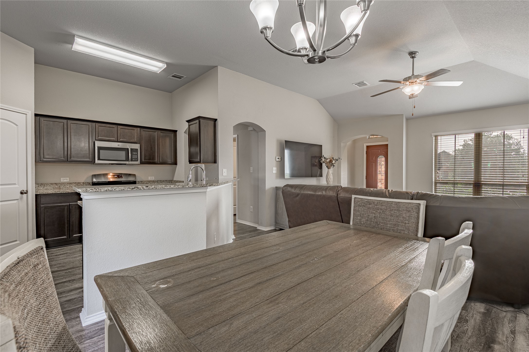 133 Bates Court Huntsville, TX 77320 - Photo 7 of 31 a open kitchen with stainless steel appliances granite countertop a sink dishwasher a stove top oven a refrigerator with island and chairs