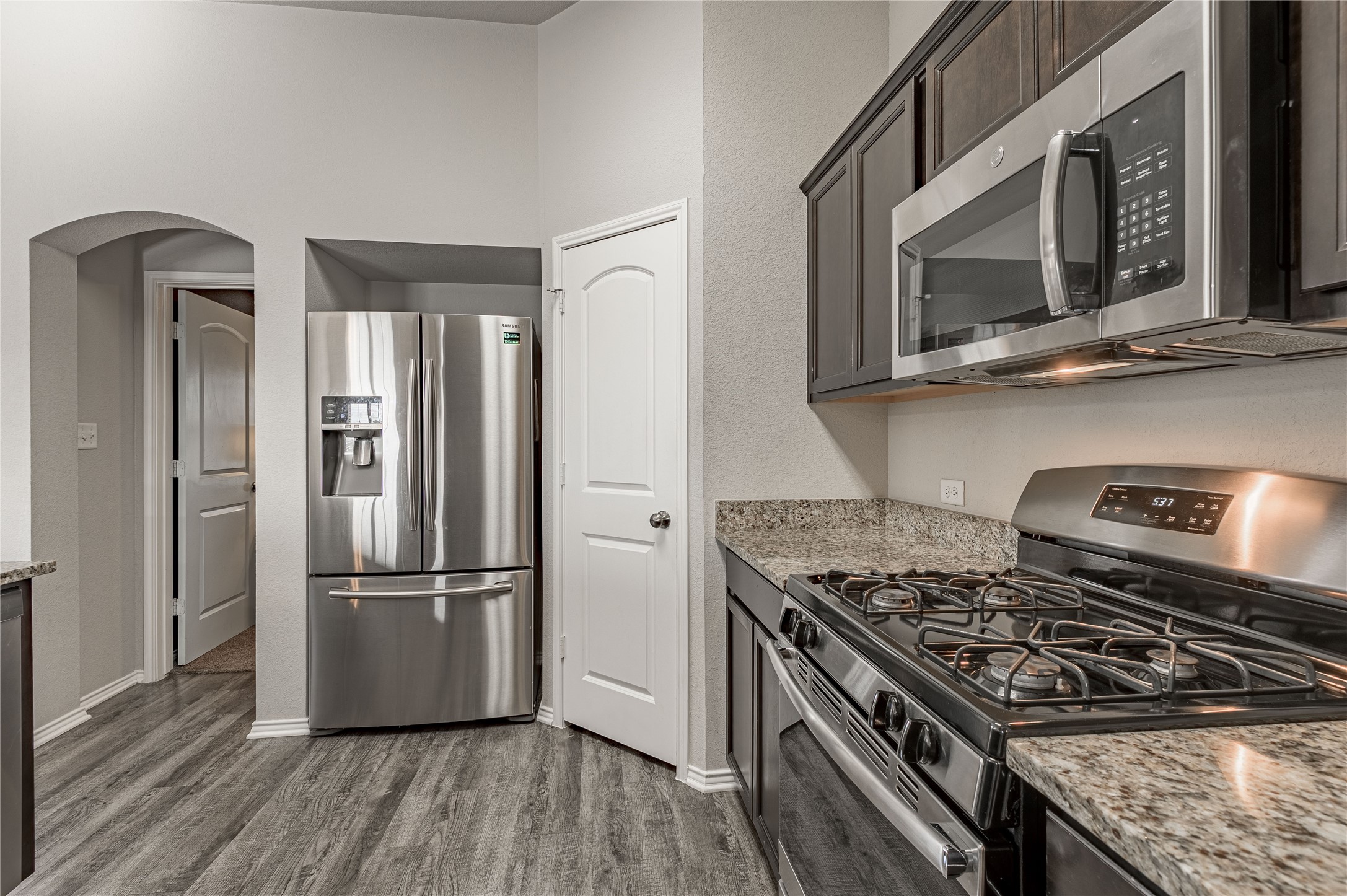 133 Bates Court Huntsville, TX 77320 - Photo 9 of 31 a kitchen with a stove and a microwave