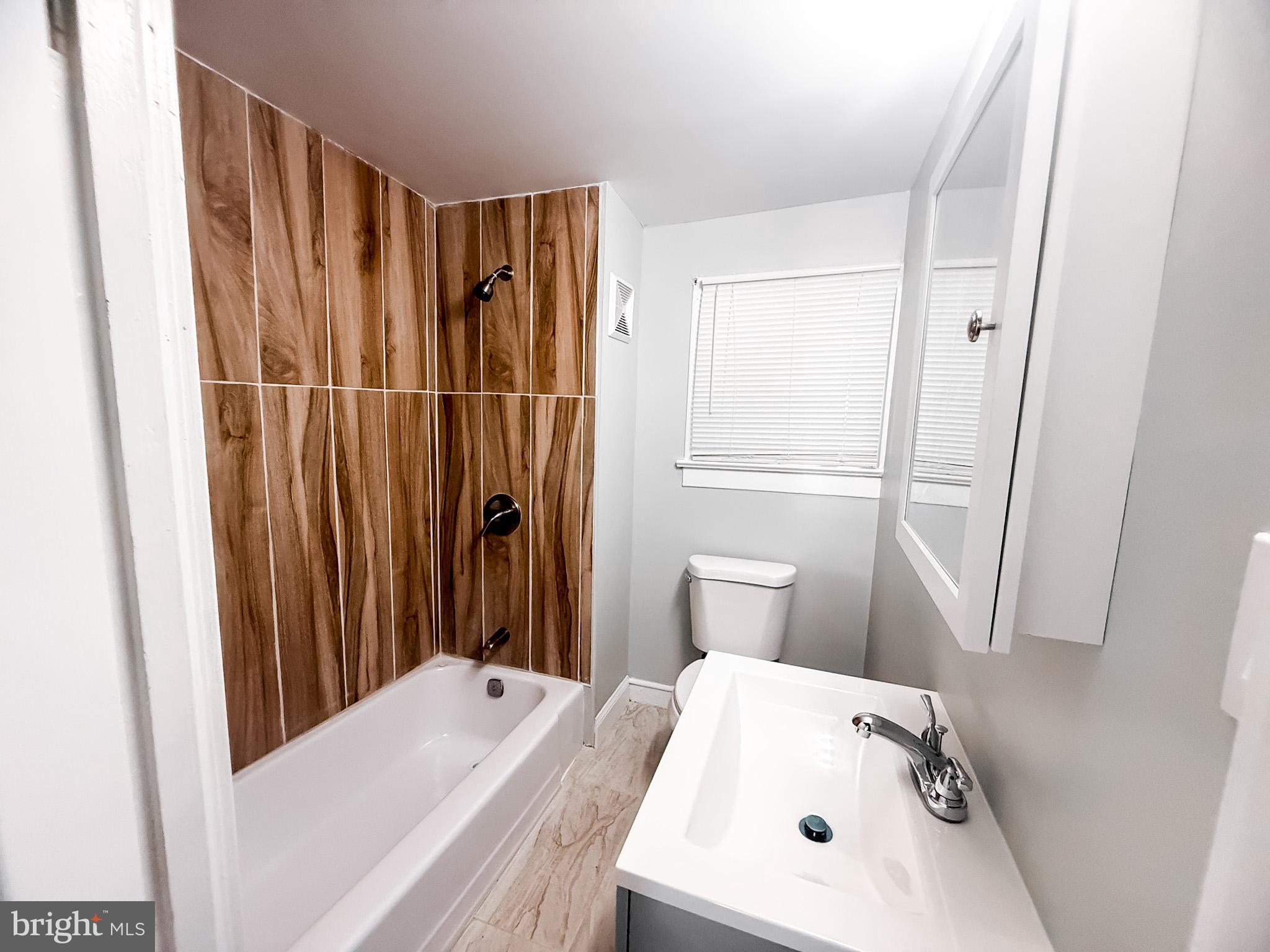 24 State Street, Unit A Penns Grove, NJ 08069 - Photo 12 of 18 a bathroom with a sink a toilet and shower