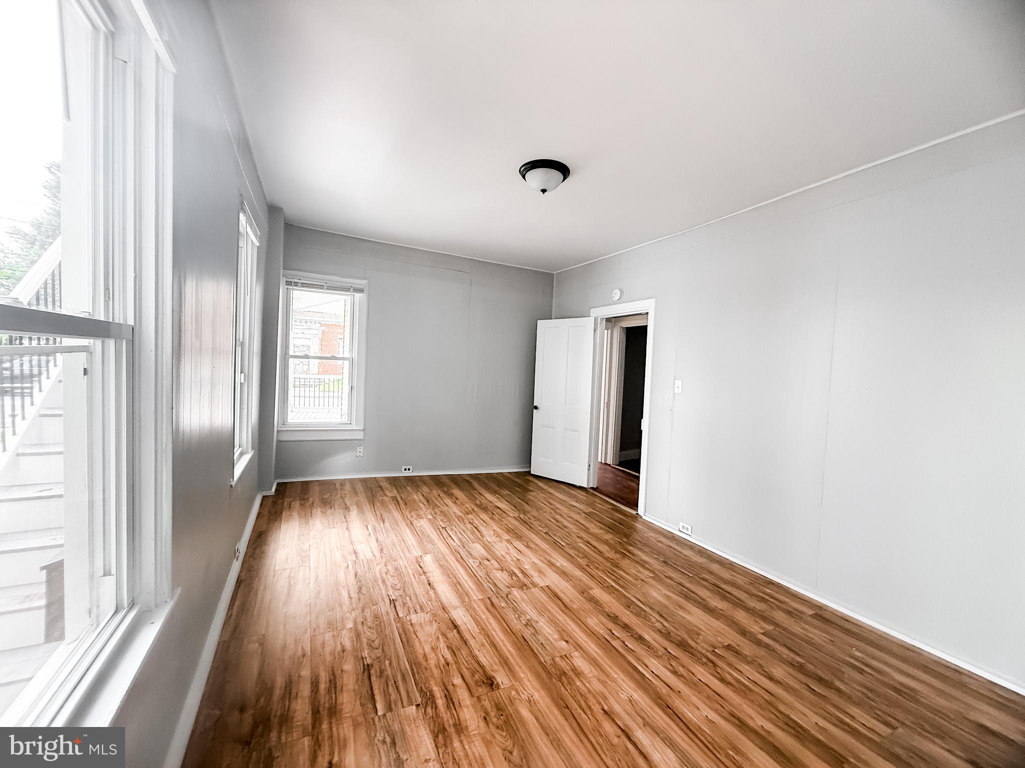 24 State Street, Unit A Penns Grove, NJ 08069 - Photo 15 of 18 a view of an empty room with wooden floor and a window