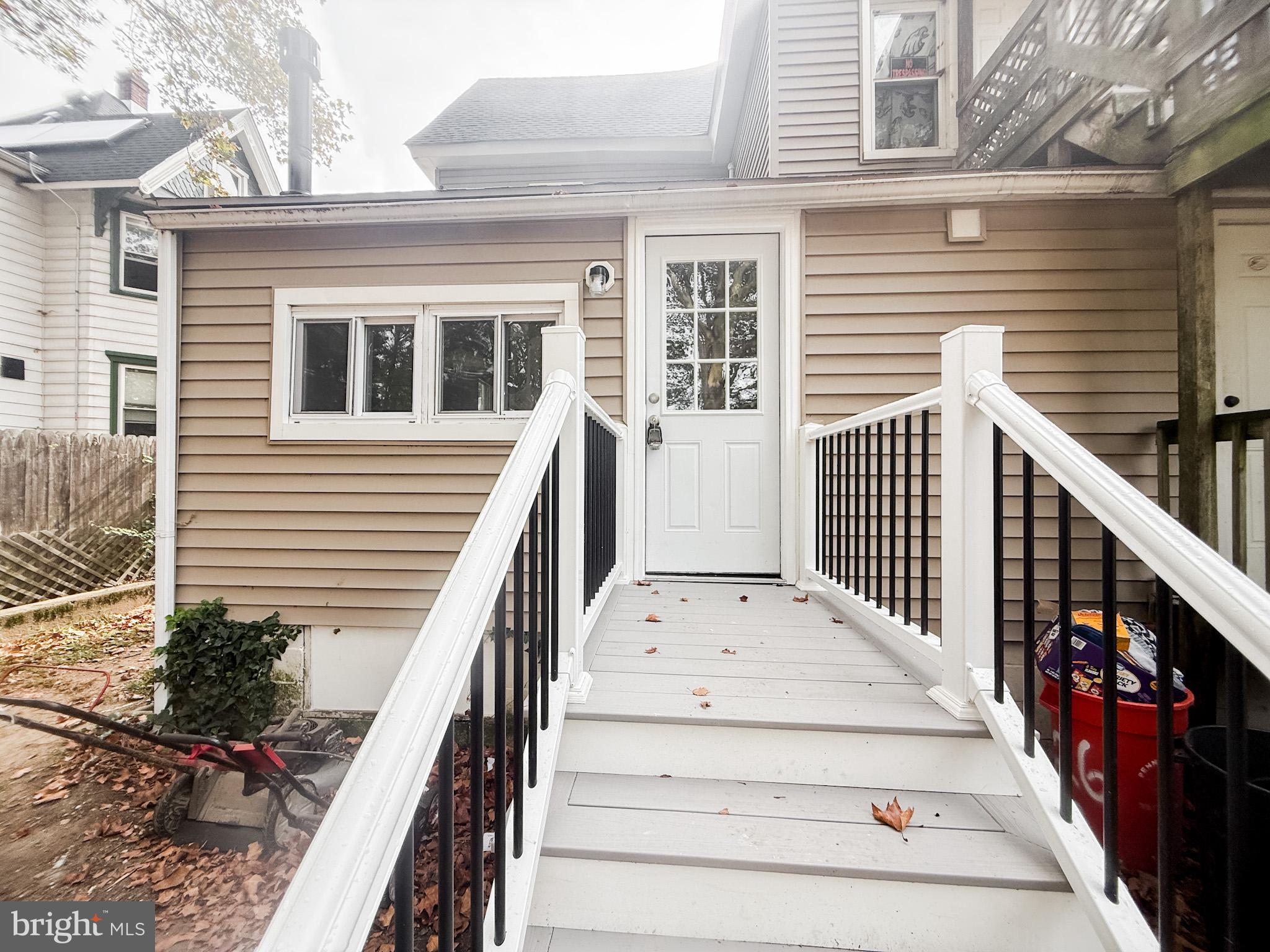 24 State Street, Unit A Penns Grove, NJ 08069 - Photo 18 of 18 a view of house with wooden stairs and a large window