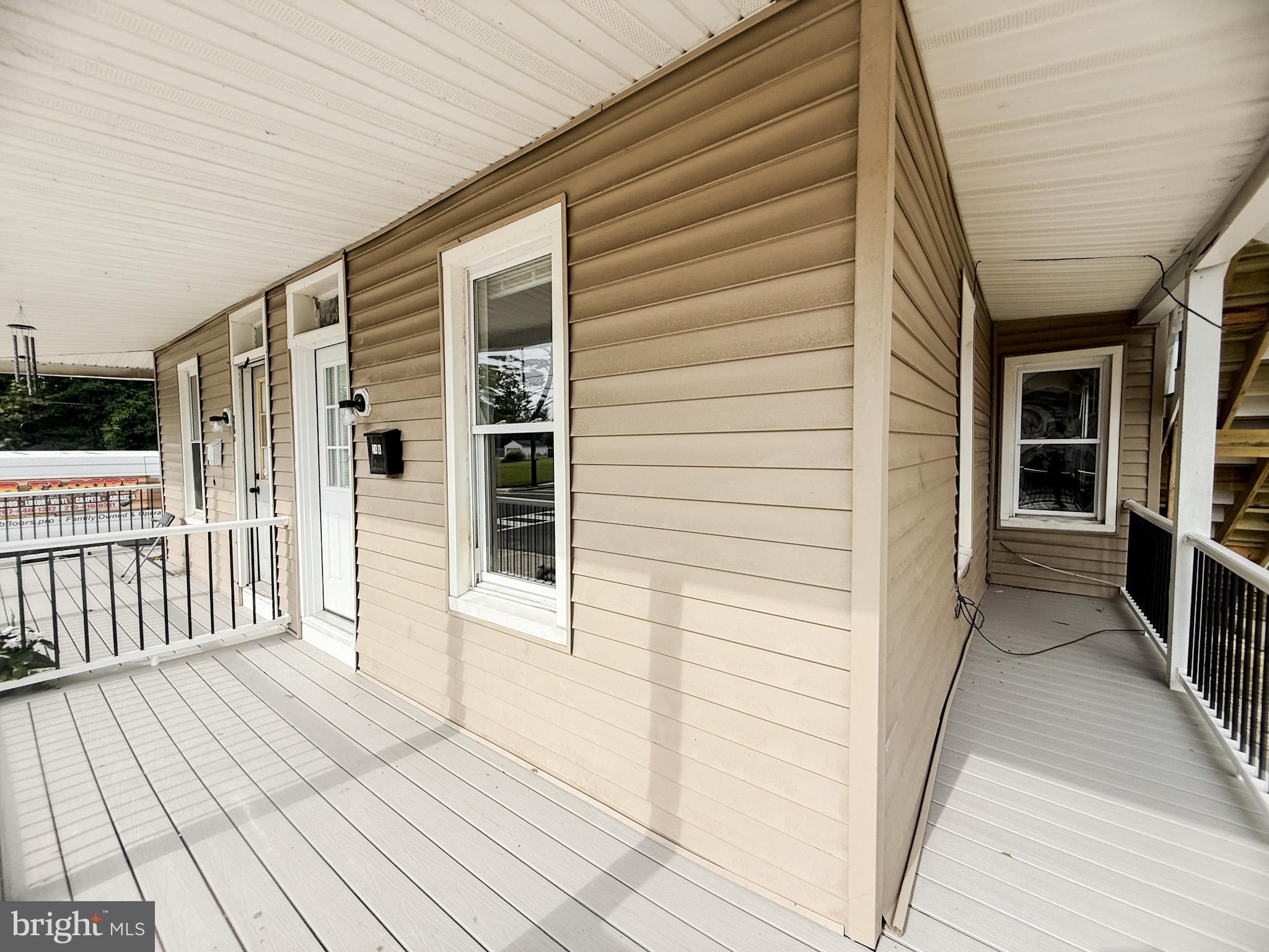 24 State Street, Unit A Penns Grove, NJ 08069 - Photo 4 of 18 a view of a porch with wooden floor and fence
