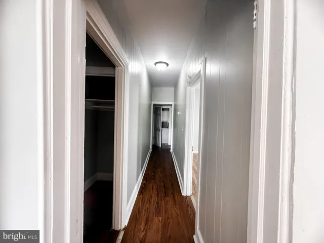 a view of hallway with wooden floor