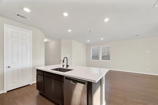 a kitchen with a sink and a refrigerator