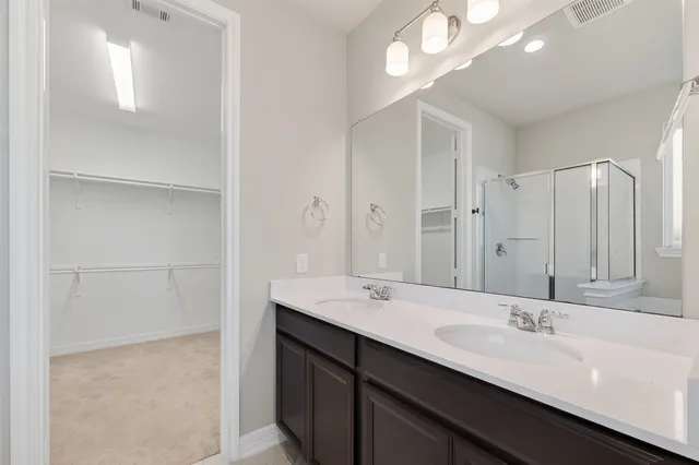 a bathroom with a double vanity sink a and mirror