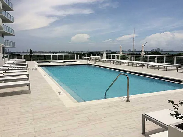 a view of a swimming pool and lounge chair