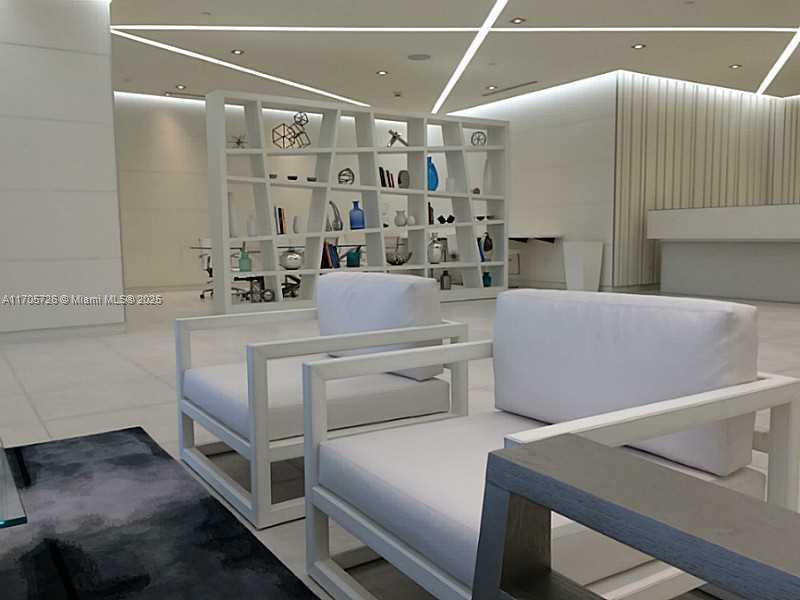 4250 Biscayne Boulevard, Unit 1104 Miami, FL 33137 - Photo 29 of 31 a room with furniture and a chandelier