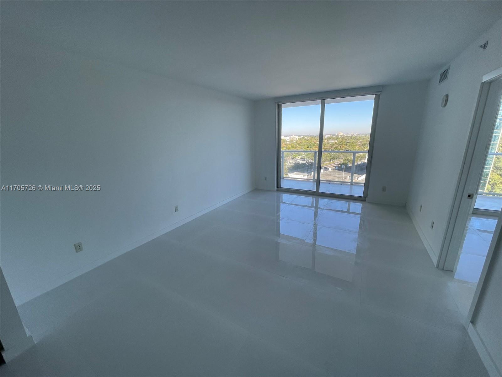 4250 Biscayne Boulevard, Unit 1104 Miami, FL 33137 - Photo 5 of 31 an empty room with windows