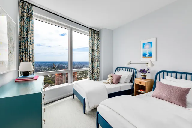 a bed room with a bed and a large window