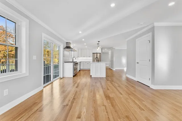 a bathroom with a sink a toilet a shower and a window